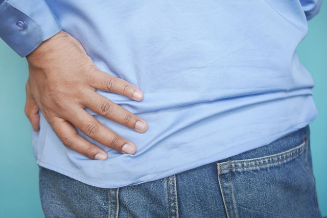 person touching his back